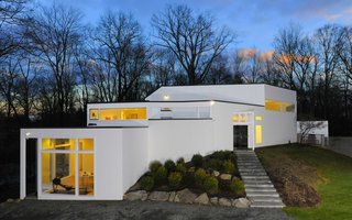 12 Modern Marvels in New England - Photo 6 of 12 - Designed by Anthony Wooiner, this striking residence in New York's northern suburbs blurs the line between indoors and out, flanked by dramatic glass walls that embrace the home's natural surroundings. It now awaits its next residents.