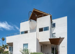 Slim Is in For These 10 Skinny Homes - Photo 9 of 10 - Three stories of ocean views, and a unique boat-bow balcony offers a bit of humor to this beachy neighborhood.