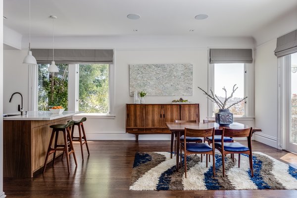 Modern home with dining room, table, ceiling lighting, pendant lighting, chair, and dark hardwood floor. Open Dining / Kitchen / Living - European fumed chestnut cabinetry, featuring quarter-sawn, sequenced veneers and an oiled finish, Louis Poulsen pendant lights, Recreated original baseboards, window trim, and picture rail from original 1905 detailing, Vintage rosewood bar stools by Erik Buc, Vintage Danish dining table by Gunni Omann Photo 11 of Castro Residence