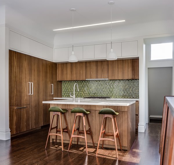 Modern home with kitchen, marble counter, dark hardwood floor, wood cabinet, pendant lighting, mosaic tile backsplashe, and undermount sink. Kitchen - European fumed chestnut cabinetry, featuring quarter-sawn, sequenced veneers and an oiled finish, Miele appliances, Heath tile backsplash, Calacatta countertops, Louis Poulsen pendant lights, Recreated original baseboards, window trim, and picture rail from original 1905 detailing, Vintage rosewood bar stools by Erik Buch Photo 6 of Castro Residence