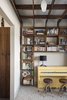 One of the family’s favorite rooms in the house is the library. Young’s wife is an avid reader and founded a children's literacy nonprofit here in Orlando. The couple needed a space for everyone’s books, and finding a place where they could display them side-by-side was important. The bookshelf, part of a larger shelving grid, is built around a bright yellow piano. Photo 14 of 1600 Lakeside modern home