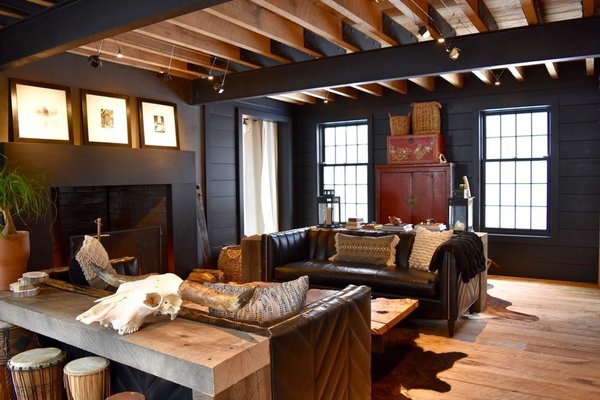 Wide Plank oak floors, hand milled, 480 pounds of cut nails for install flooring throughout the home, custom leather sofas with chevron pattern from "Of Iron & Oak", silver maple flitch sawn coffee table, cast concrete fireplace surround, exposed oak and steel frame, antique furniture, and long horn skull Photo 5 of The Lodge modern home