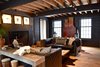 Wide Plank oak floors, hand milled, 480 pounds of cut nails for install flooring throughout the home, custom leather sofas with chevron pattern from "Of Iron & Oak", silver maple flitch sawn coffee table, cast concrete fireplace surround, exposed oak and steel frame, antique furniture, and long horn skull Photo 5 of The Lodge modern home