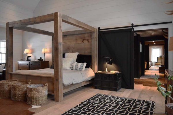 1,400lb King Bed. Built in the space from extra timbers not used in the construction of the home. 20" wide oak planks make up the head and foot boards. 4' wide sliding doors, 4' wide traffic areas through the home to provide ease of flow, wide plank oak flooring milled my hand onsite, all wood walls and ceilings. Photo 11 of The Lodge modern home