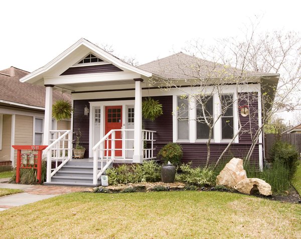The exterior of the home had multiple repairs undertaken to ensure its longevity and new landscaping was installed to bring the house to an easier maintenance level for the homeowner. Custom features like the mailbox and the railings along the front deck were designed to enhance the Asian flair of this bungalow. Rocks and water features were added throughout the landscaping to bring additional Asian influences to the home. Photo of Asian Bungalow modern home