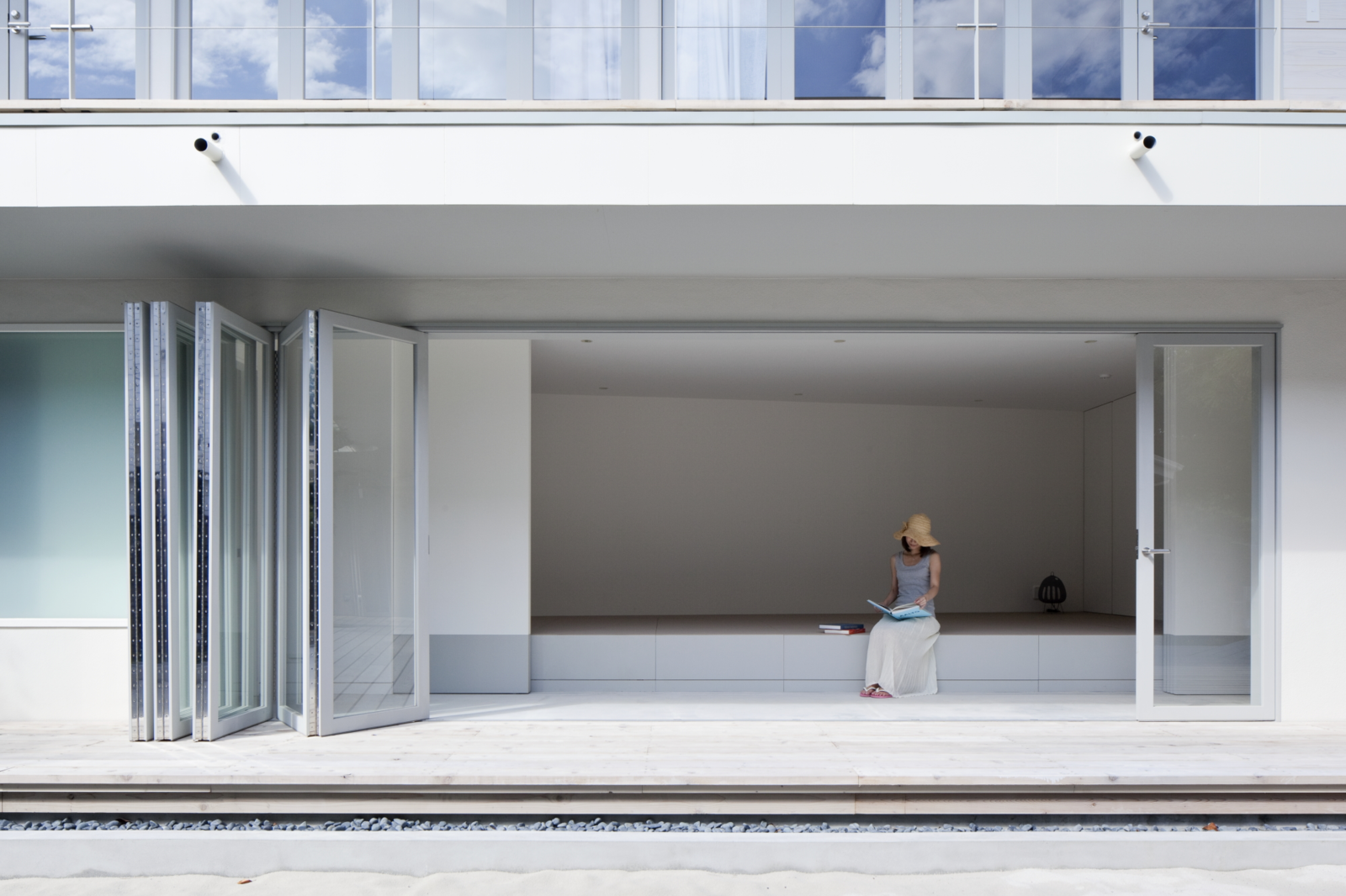 Designed by Vincent Yeuh of YJP, the Seaside House was created to act as an experience, rather than simply a building. The continuous flow of the home between indoor/outdoor is intended to highlight man's connection to nature, while allowing for a seamless shift between inside and outside living. Located a few steps from the beach, the two buildings that make up the home are constructed of wood and concrete, with elements of traditional Japanese minimalism and echoes of bygone barn structures throughout.