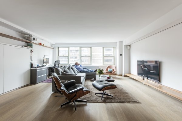Modern home with living room, chair, sofa, and medium hardwood floor. Not one to miss the tiniest of details, Frans had the entire apartment wired for temperature, lighting, and sound control he conveniently accesses via phone. They not only got the mudroom, but also managed to fold in multiple, flexible spaces to this origami apartment. Their new “studio” might be the only one in all of Manhattan with as many separate rooms as they now have, perfectly positioned within one unique space. Photo 11 of Gramercy Studio Renovation