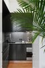 Modern home with Kitchen. After moving the wall between the kitchen and living areas, Kate and Arthur were able to configure an L-shaped--which was critical in adding a full height refrigerator, full height pantry, and an 18” dishwasher. They opted for a minimalist black and white aesthetic, with dark black-green cabinets, and a dark soapstone counter.
Photo of Overhaul of an Upper West Side Brownstone Apartment