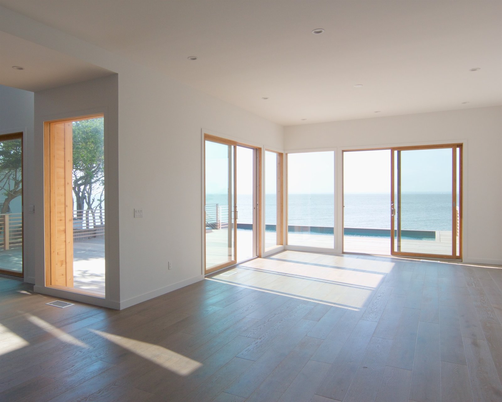 Living room with view of pool and bay
