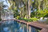Modern home with Outdoor, Back Yard, Garden, Trees, Side Yard, Hardscapes, Shrubs, Gardens, Swimming Pool, Walkways, Small Pool, Landscape Lighting, Pavers Patio, Porch, Deck, and Standard Construction Pool. Using the same material for the pool coping and the paths helps the garden feel more open and contemporary garden. The original wood deck was rotten and need replacing. Living in a subtropical area one must have a certain amount of airflow under wood decking and termites are also an issues. The paving was chosen for practical as well as aesthetic reasons. Photo 8 of Fred's Garden