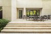 Modern home with outdoor, shrubs, hardscapes, back yard, walkways, large patio, porch, deck, pavers patio, porch, deck, and landscape lighting. The hardscape of the patio was designed to match the architecture. Clean lines and a modern feel were an important factor for the clients. Indoor/outdoor living is a must for this outdoor dining area. Accordion doors allow for the refreshing winter breeze to blow throw the house and allow for an easy transition between the front of the property and the back. Photo 8 of Key West Modern