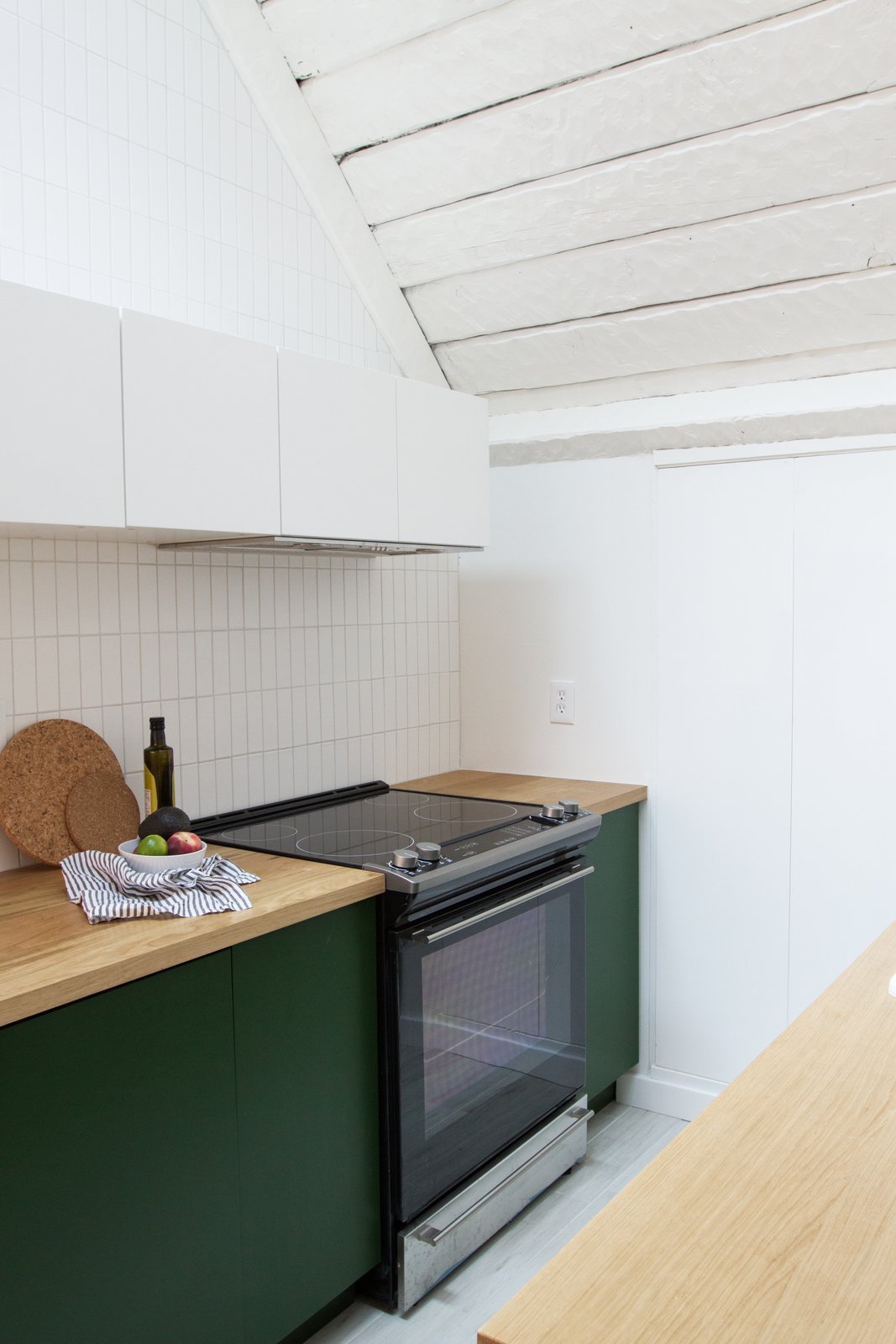 Samuel carried the handmade Fireclay tile up to the ceiling and painted the walls Polar Bear by Behr.