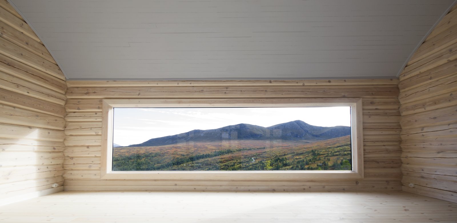 The panorama window in the barrel-vaulted living room. "The low position of the window emphasizes that this is a room to sit and relax," says the architects. This room was built with 19th-Century notched logs.