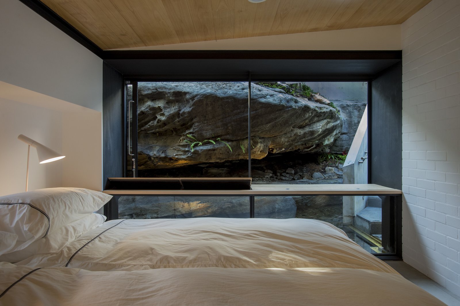 The rock ledge provides natural privacy from the street and ensconces occupants in the site's beauty.