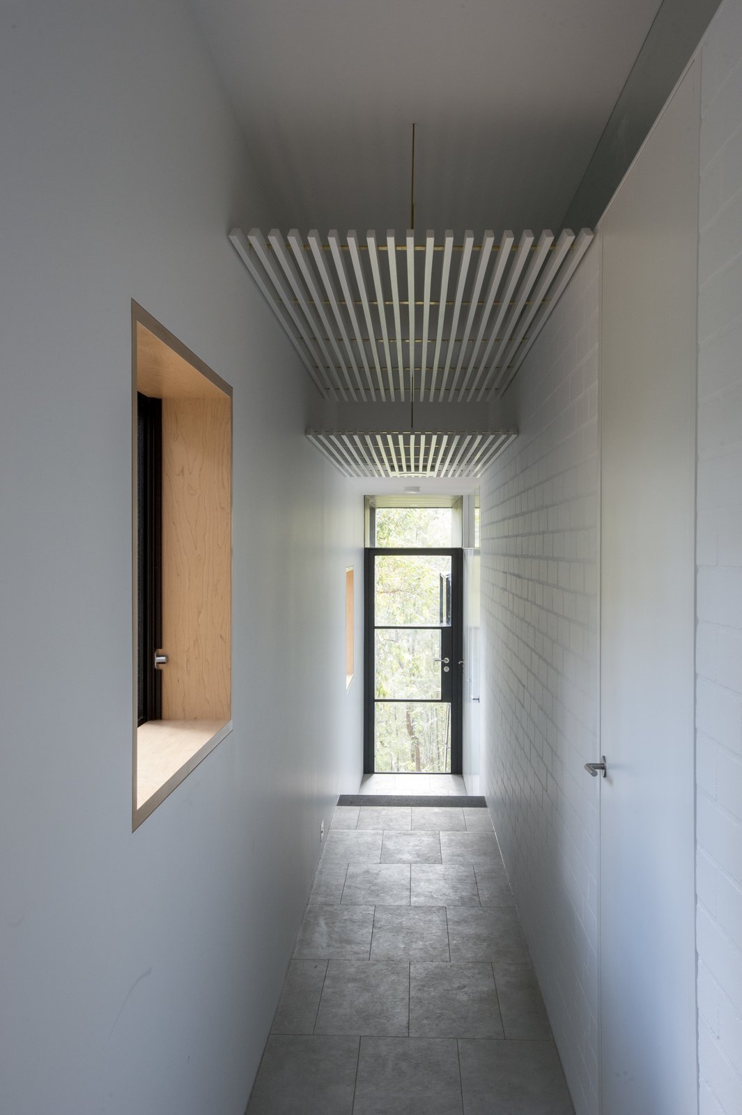 Passageways take advantage of the Southside of the house, so that living areas and bedrooms receive Northern sunlight. White walls are satin-finished or bagged brickwork.