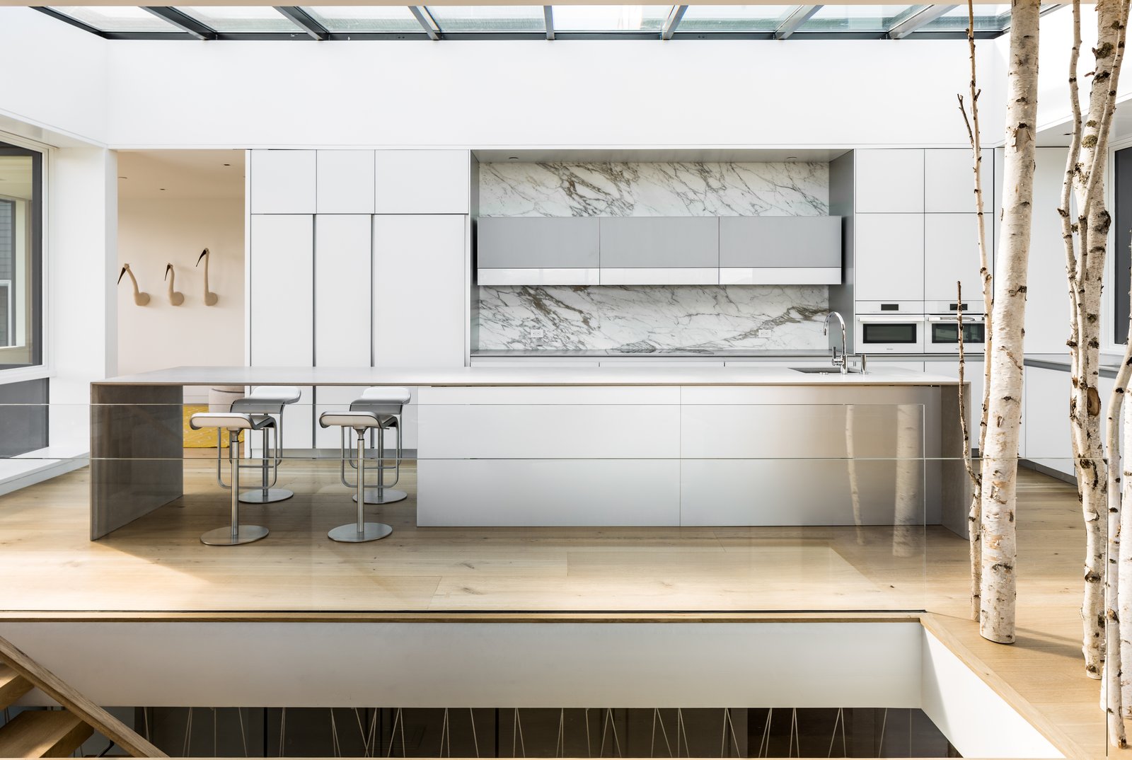 A 12 foot by 24 foot skylight, extending the full width and length of the kitchen, floods natural light into the core of the open, connected living spaces.