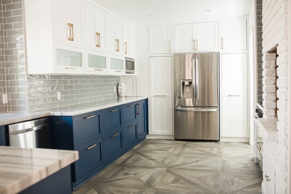 Modern home with kitchen, colorful cabinet, recessed lighting, marble counter, porcelain tile floor, porcelain tile backsplashe, undermount sink, refrigerator, dishwasher, and microwave. Many older homes suffer from a history of odd remodels, and this 60-year old home had its own peculiarity - there was a strange window in the kitchen that looked into the garage. Deleting the window gave new space for a long counter with more upper and lower cabinet space. Adding glass doors to the adjoining laundry room and rear exterior door brought fresh light into the space. Photo 12 of Diablo Ranch