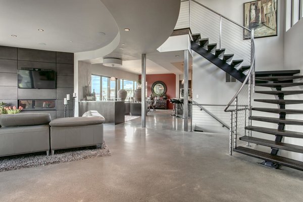 Modern home with side yard, front yard, trees, shrubs, grass, walkways, flowers, large patio, porch, deck, stone patio, porch, deck, landscape lighting, and living room. As soon as you enter this one of kind masterpiece you will notice details rarely seen such as this custom curved steal beam with concrete stair treds and custom cable railing!
See more: www.DowntownKirklandModern.com Photo 2 of Downtown Kirkland Modern