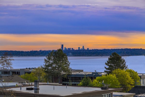 Modern home with front yard, side yard, trees, shrubs, grass, flowers, stone patio, porch, deck, landscape lighting, large patio, porch, deck, walkways, sectional, ceiling lighting, concrete floor, gas burning fireplace, and outdoor. Views of Seattle Skyline, Lake Washington and the Olympic Mountains can be viewed from most rooms of this house plus the outdoor covered deck space!
See more: www.DowntownKirklandModern.com Photo 3 of Downtown Kirkland Modern