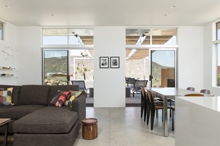 The living room of the main house has direct connections to the outdoors and the patio.