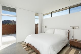 The master bedroom looks out at desert peaks.