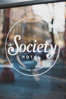 A Chic Portland Hotel Offers Lodging As Affordable as $35 a Night - Photo 1 of 10 - Window graphics provide unobtrusive and elegant signage on the exterior glazing of the historic facade.