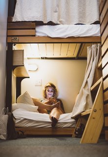 A Chic Portland Hotel Offers Lodging As Affordable as $35 a Night - Photo 6 of 10 - The wood-framed bunk beds come complete with a reading light and a privacy curtain.