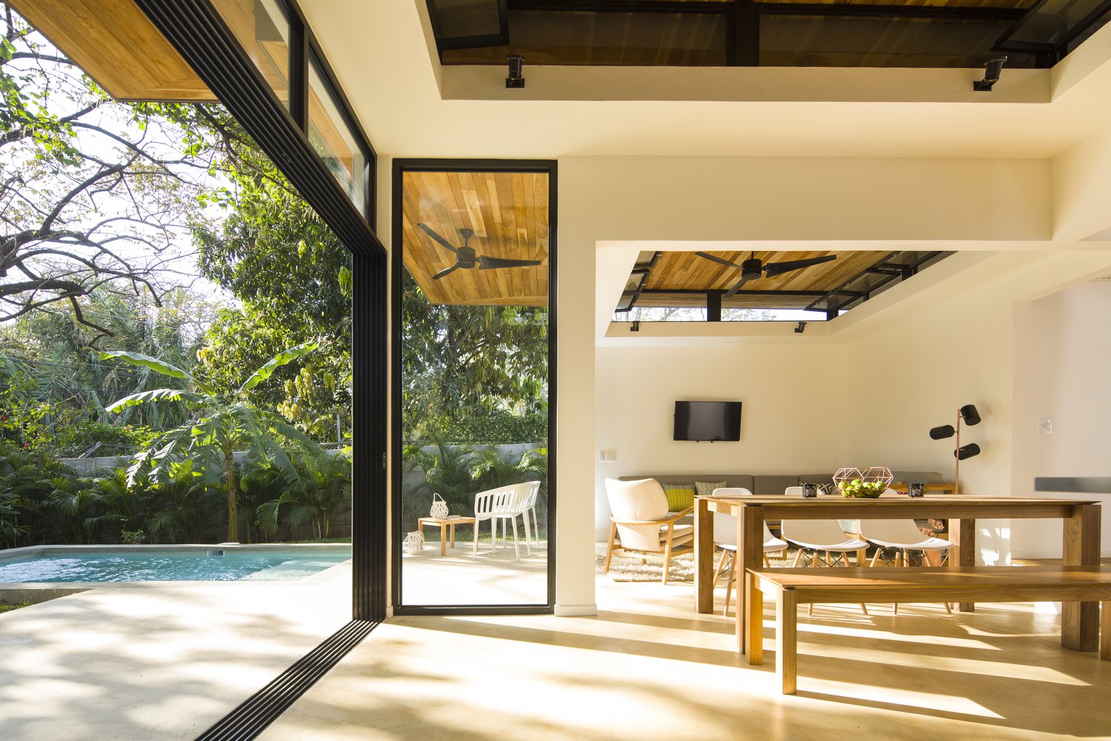 Large, operable glass doors and clerestory windows provide a fluid transition between the interior retreat and the exterior landscape.