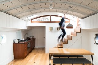 Londoners Can Live in This Scandinavian-Inspired, Converted Barge For $424K - Photo 3 of 9 - A dipped terracotta pendant light by Hand and Eye Studio London hangs above the Brunel by Heals dining table and benches. 