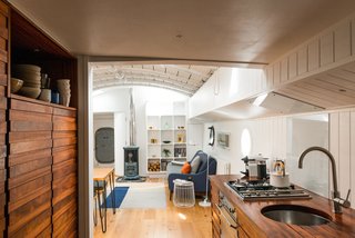 Londoners Can Live in This Scandinavian-Inspired, Converted Barge For $424K - Photo 4 of 9 - A Saikai Kaico Japanese enamel kettle and hand thrown dishes by David Green Ceramics sit proudly in the galley kitchen. 