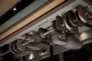 A Steel-and-Glass Addition With a Giant Hangar Door Maximizes Indoor/Outdoor Living - Photo 7 of 9 - Gears allow the large, mechanical door to open with the turn of a crank. 