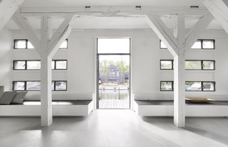 A Converted Warehouse in Amsterdam Boasts Soothing Interiors of Concrete and Wood - Photo 3 of 9 - Existing, renovated windows provide ample daylight and views of the surrounding shipyard. 