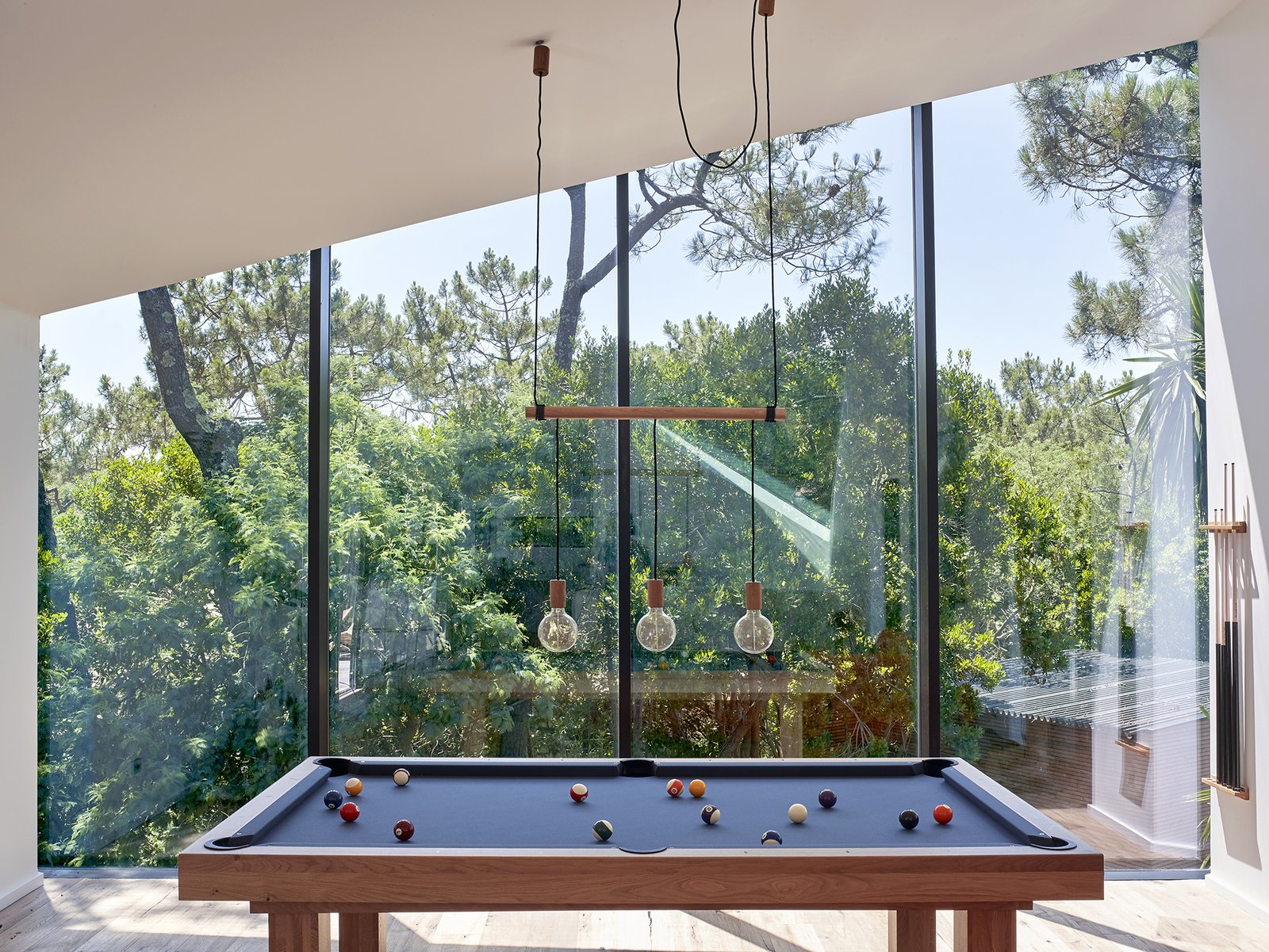 In the Game Room, slanted windows directly follow the roof line, creating a seamless connection.