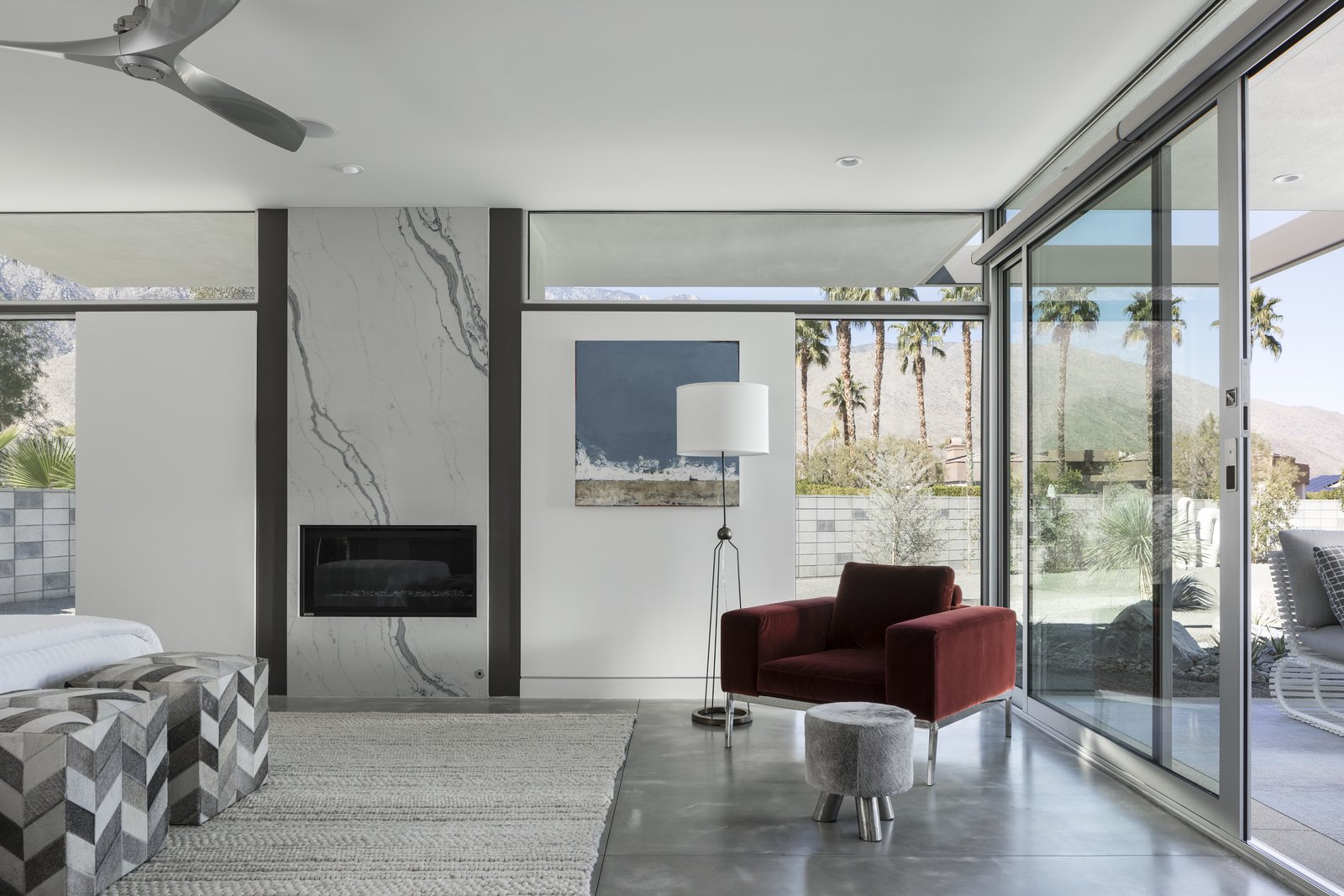 The Master Bedroom is completed with an elegant fireplace and glass surrounds. Large, sliding glass doors open directly onto the outdoor patio.
