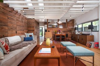 Reclaimed wood is so hot right now. There is absolutely no limit to the ways in which you can apply this sort of technique, such as the living room of Ashland Residence in Santa Monica, looking south towards the kitchen and rear yard, with open ceiling framing.