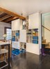Modern home with dining room and storage. One of the major features of the project was a new cabinetry unit spanning the stairway between the living room and kitchen. This full-height unit now houses their collections, hobbies, books, as well as essential everyday items. The mix of opened and closed storage provides a mix of function and aesthetics, keeping clutter out of sight, but breaking up what could have otherwise been an overpowering monolithic structure. Photo 10 of Modern Mix