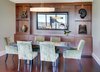 Modern home with Dining Room, Chair, Table, Medium Hardwood Floor, and Storage. In the dining room, we designed new custom cabinetry with contractor Solid Vision Interiors, to provide the Drinkards with plenty of storage and display space. Pieces in the art niches are Asian antiques from Glenn Richards in Seattle. Custom mirror from Museum Quality Framing perfectly reflects the city view. Pendant light from Hubbardton Forge; dining table from Michael Trayler; chairs from A. Rudin upholstered in Summer Hill fabric. Photo 19 of Downsize Upstyle