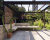 Modern home with Outdoor, Back Yard, Gardens, Flowers, Hardscapes, Garden, Shrubs, Small Patio, Porch, Deck, Decking Patio, Porch, Deck, Metal Patio, Porch, Deck, Stone Patio, Porch, Deck, Concrete Patio, Porch, Deck, and Wood Patio, Porch, Deck. The combination of a low concrete wall and built-in bench creates an intimate seating area that acts as an extension to the kitchen and dining room. Another steel trellis above creates an armature for more plants that will fill in and provide shade. The terrace is topped with blue stone and wood screens give the plants a ladder on which to grow. Photo 4 of Cambridge Terrace