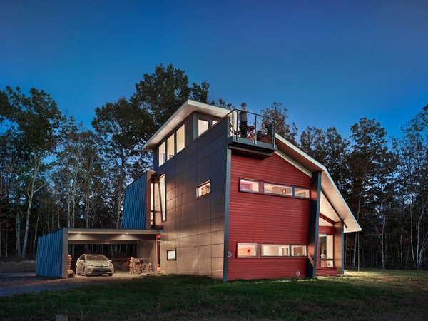 Modern home with outdoor, back yard, and small patio, porch, deck. The architects designed the home to act as a solar chimney: ventilation flows from the lowest windows on the ground level to the highest windows in the observatory. A modern interpretation of the traditional “widow’s walk”, a third floor yoga room has windows on all sides and serves as a solar chimney, exhausting out hot air. Photo of Mill Pond House