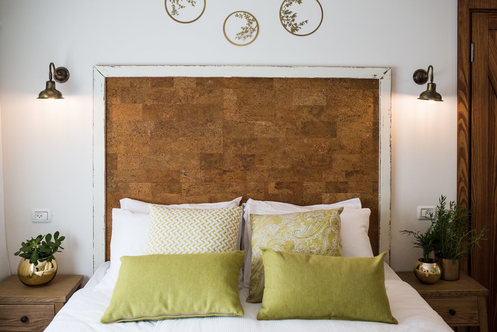 The headboard is made from cork board and painted wood