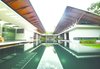 Modern home with Outdoor, Grass, Trees, Shrubs, Hardscapes, Gardens, Walkways, Flowers, Garden, Large Pool, Swimming Pool, Infinity Pool, and Landscape Lighting. The planning follows the traditional Kerala architectural concept of the three block unit – "trishala", with a public and private zone separated by a swimming pool. The design encloses a swimming pool right in the center of the house which contributes to the aesthetics and at the same time helps in evaporative cooling thus influencing the micro climate of the area -- a truly desirable attraction in the hot humid climate of Kerala. The large overhangs provide good shading thereby moderating the direct impact of summer sun and monsoon storms. Photo 5 of The Flying House