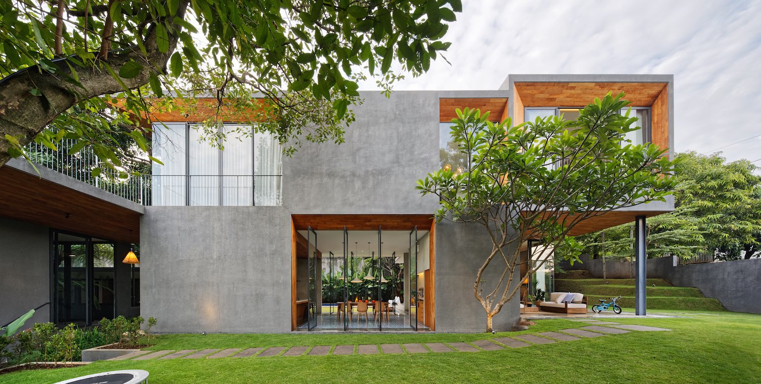 The concrete cladding contrasts with warm orange teak.