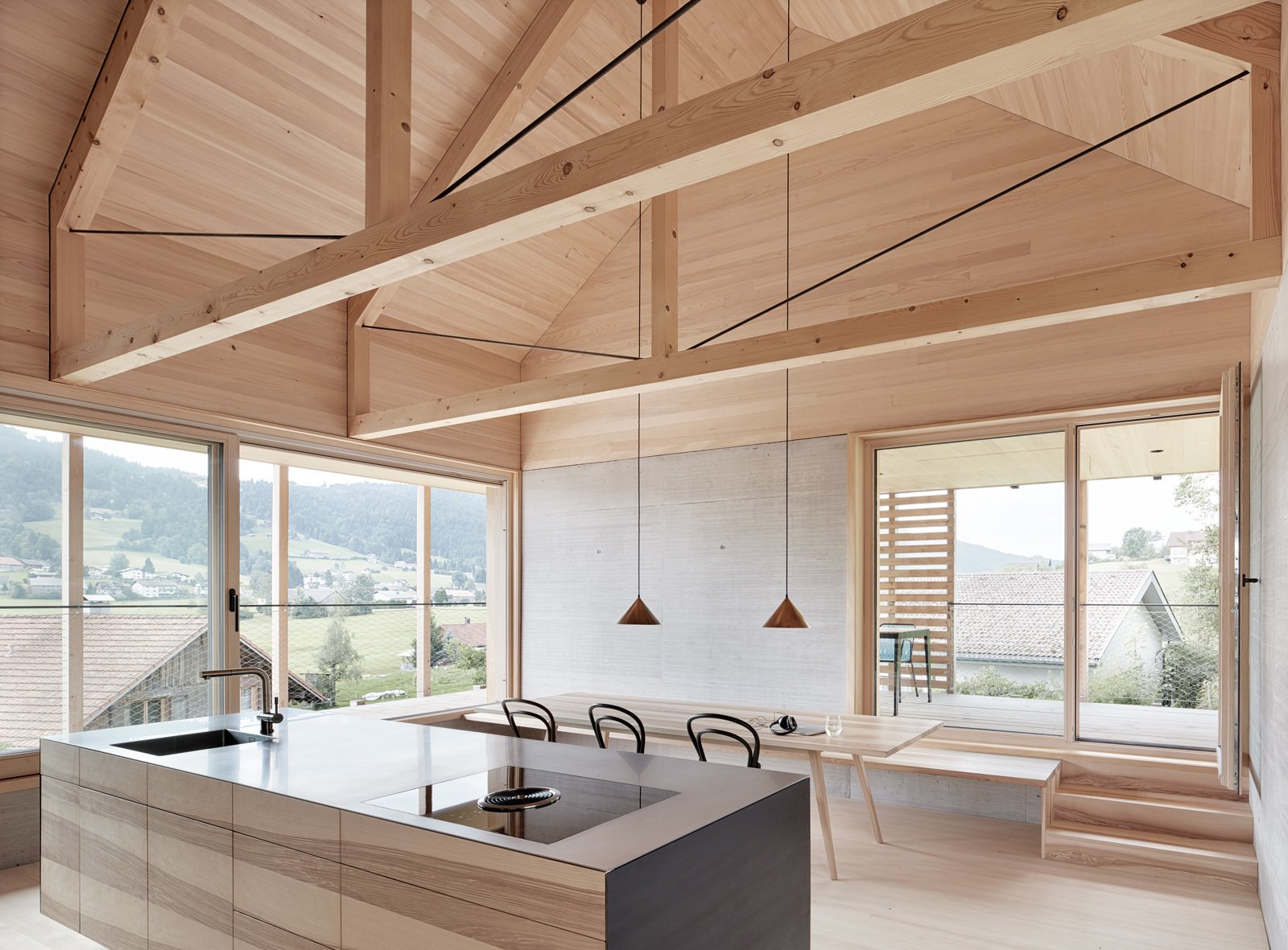 Exposed trusses celebrate the home's timber construction.