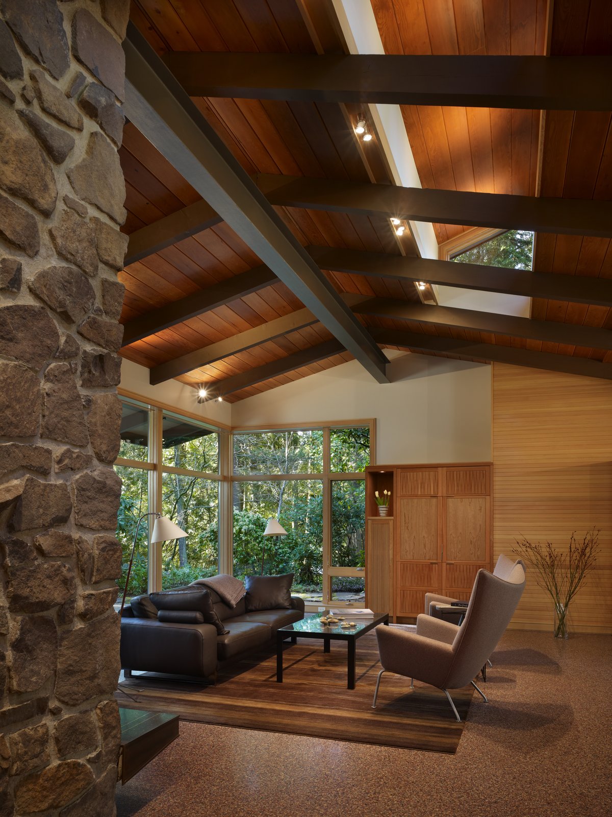 View of living area with new clerestory windows, wood paneling and casework.