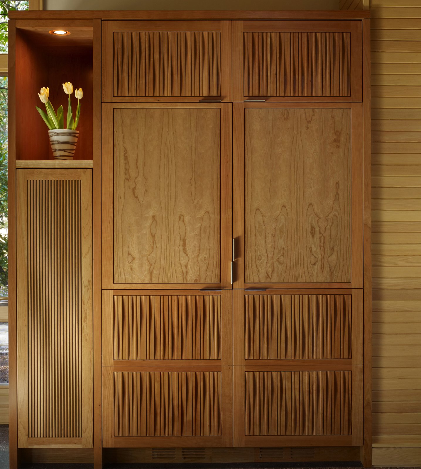 Cabinet detail with custom CNC-milled textured cherry panels