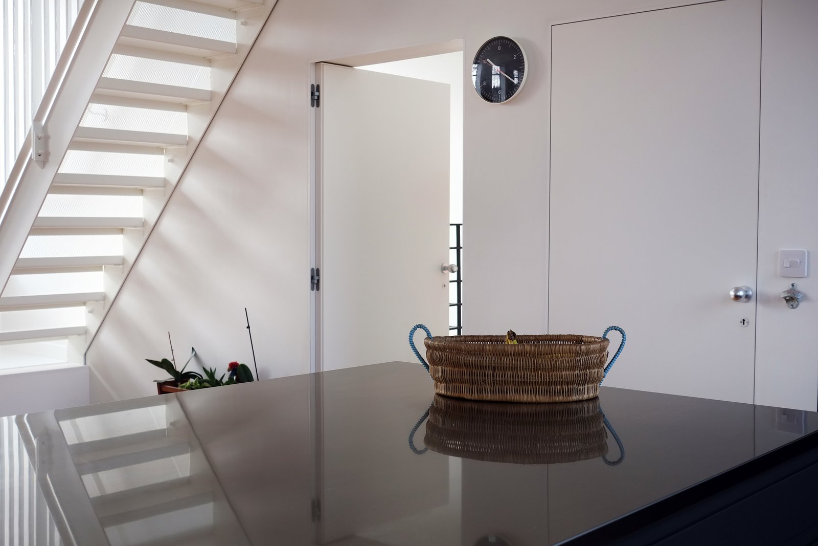 Stainless steel kitchen worktops and new metal stairs leading to roof terrace