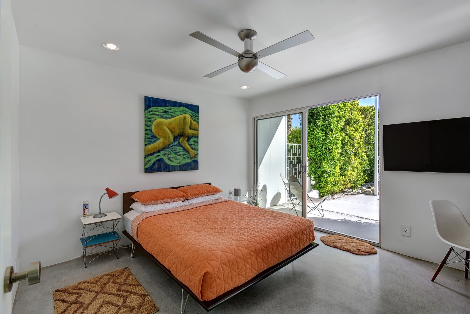 Guest bedroom with queen bed and private patio.