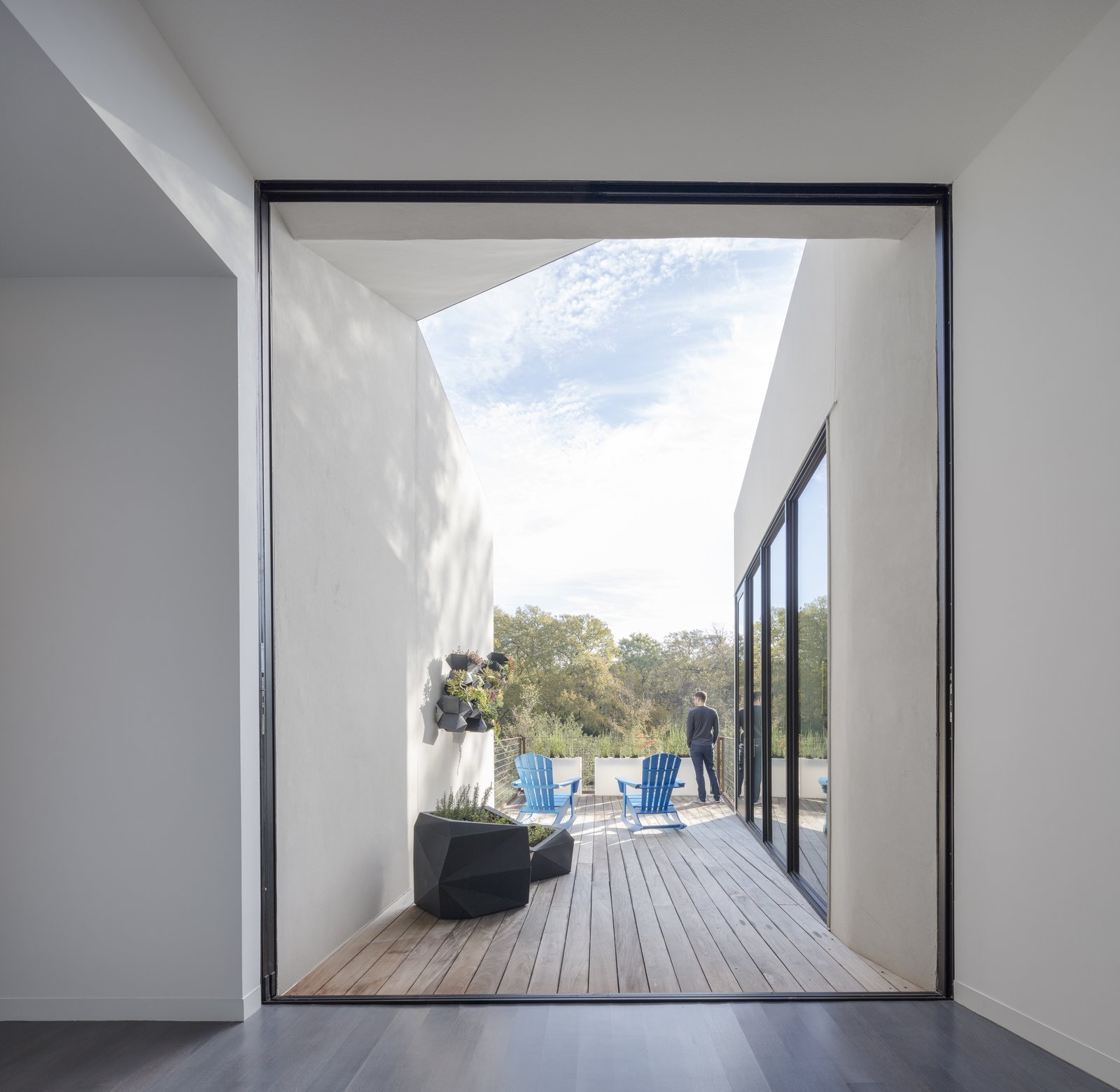 Two large multi-slide doors open up the main living space to the exterior. The opening picture faces east towards the land and water conservation project across the street; it is 12' h x 10' w.