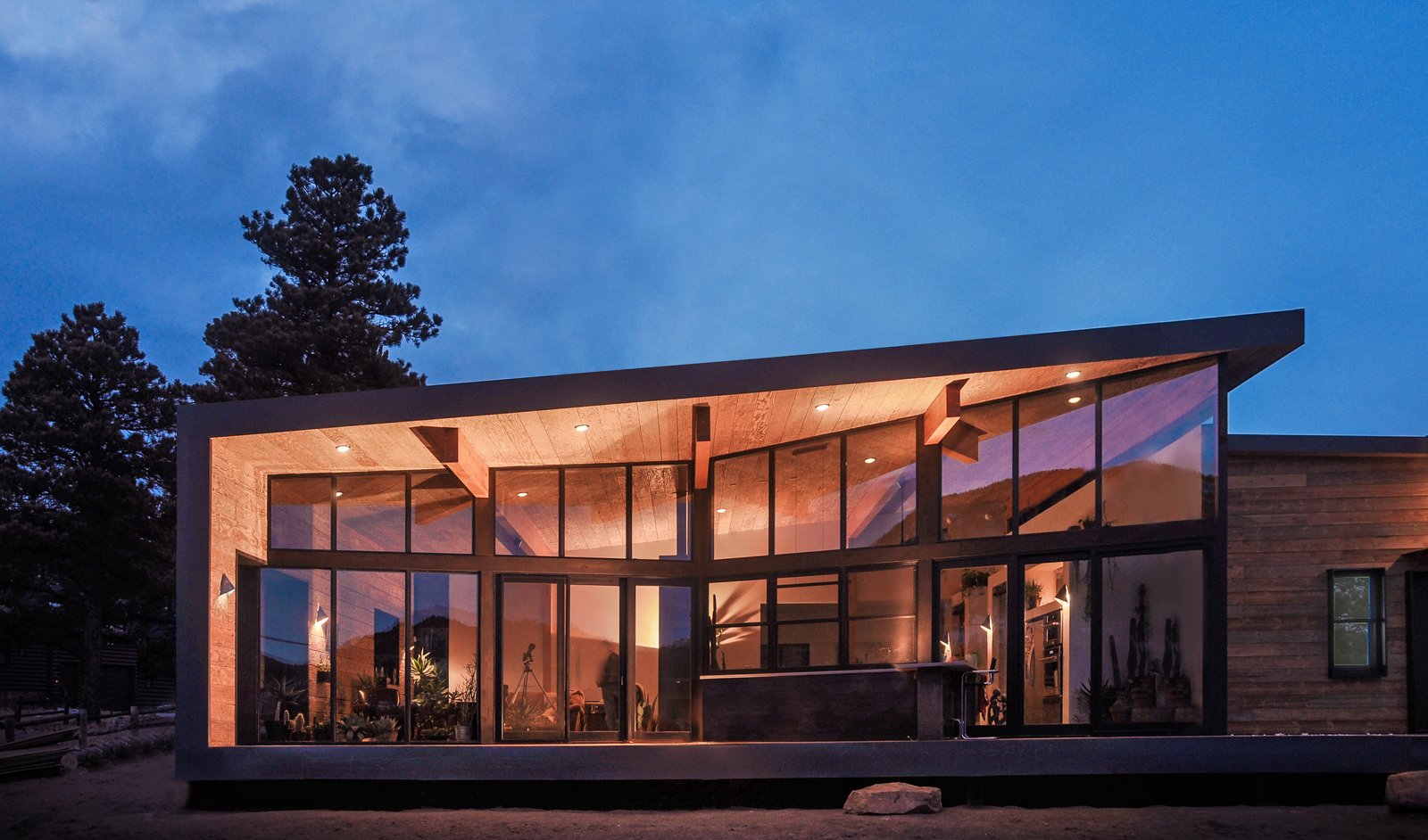 Hard shell, soft core. The industrial exterior shell wraps up and over the warm interior of the great room.