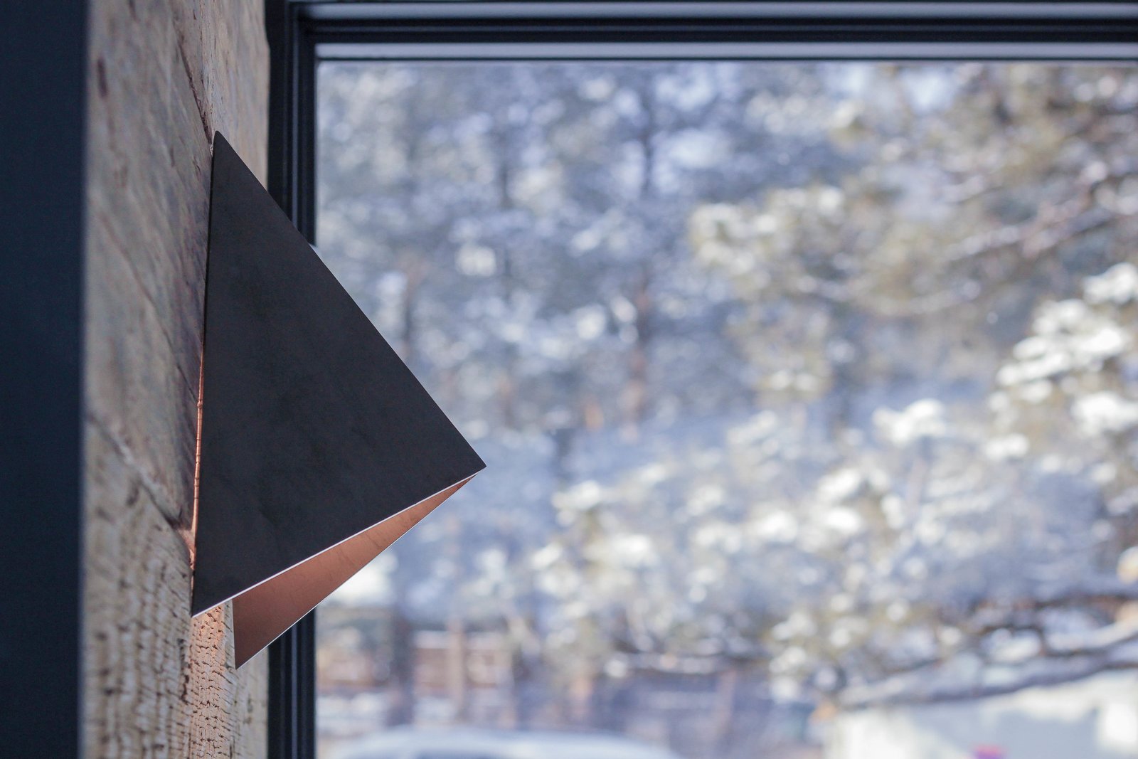 Steel sconces accent the reclaimed wood walls.